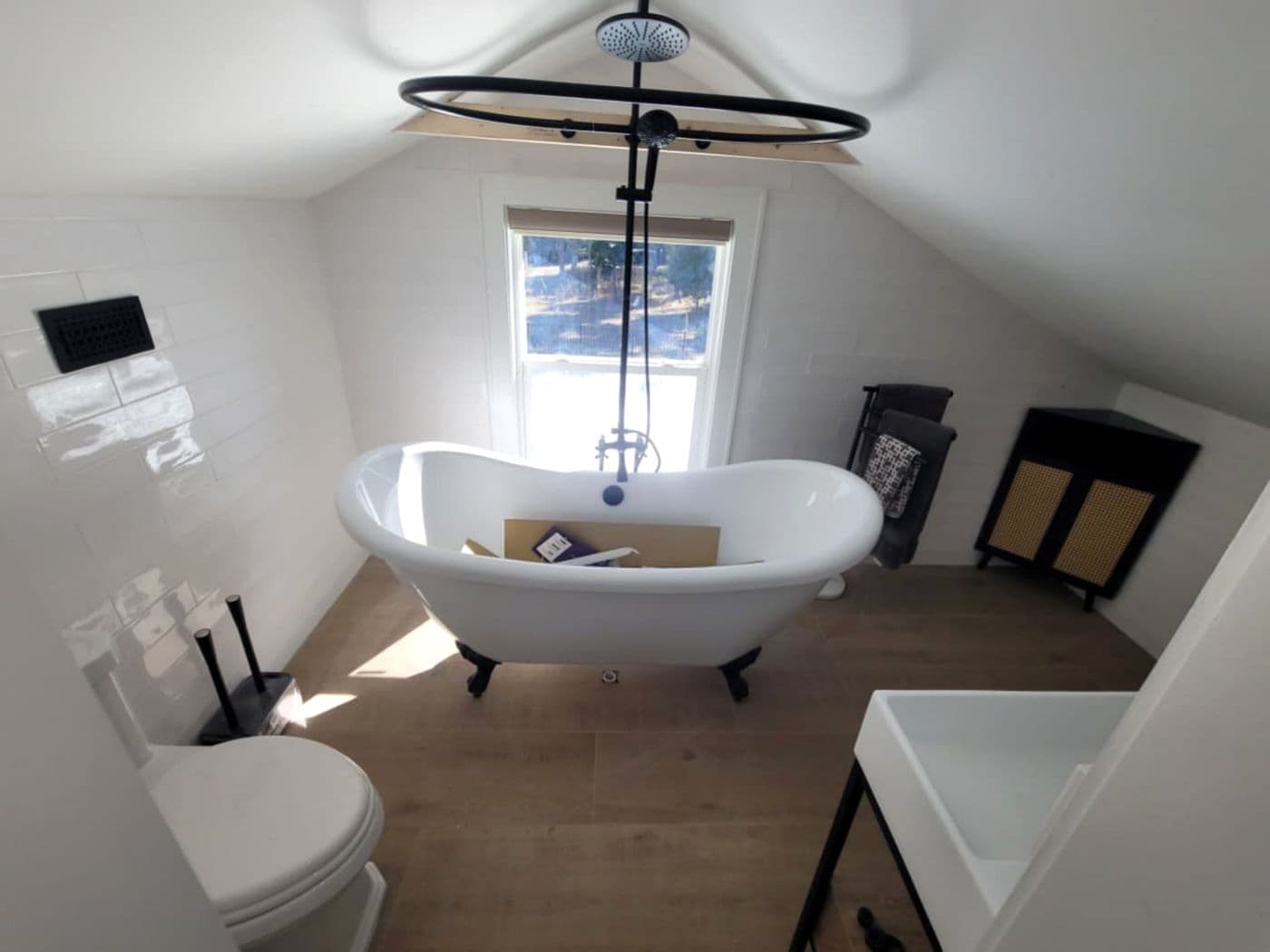 Clawfoot tub with rainfall shower ring and matte-black fixtures