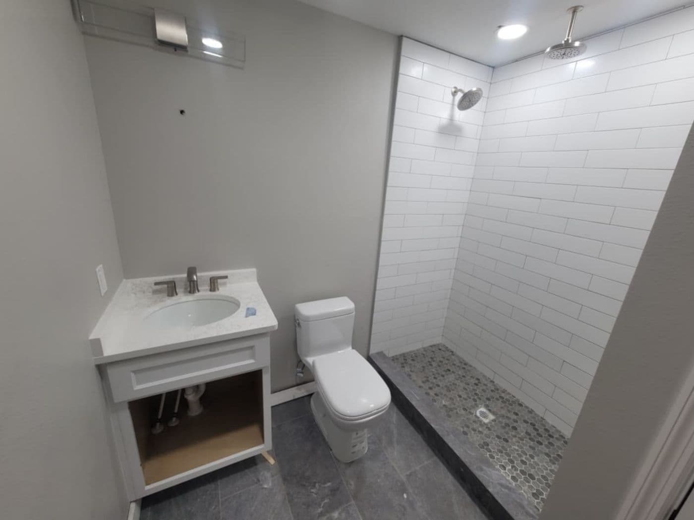 Guest bathroom with subway-tile shower and quartz-top vanity