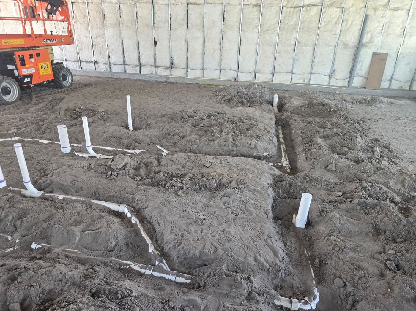 Underground drainage system set in sand before backfill on a jobsite